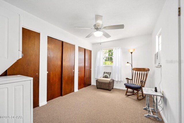 918 N Wild Olive Ave, Daytona Beach, FL 32118 - sitting room featuring carpet, stacked washer / drying machine, and ceiling fan