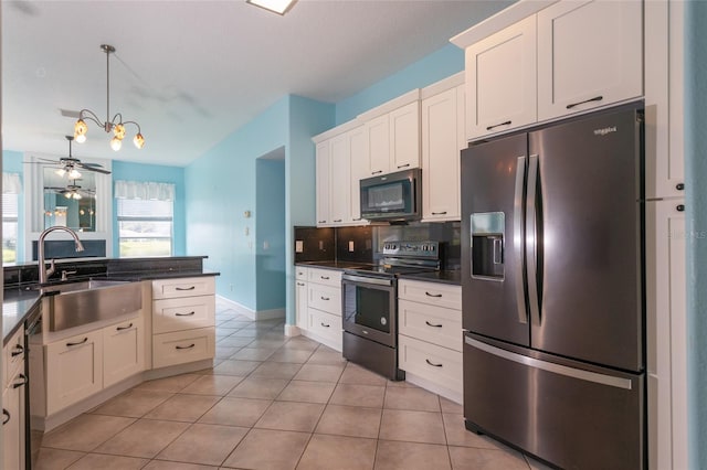38 Mount Vernon Ln, Palm Coast, FL 32164 - kitchen featuring stainless steel appliances, dark countertops, light tile patterned floors, white cabinets, and backsplash