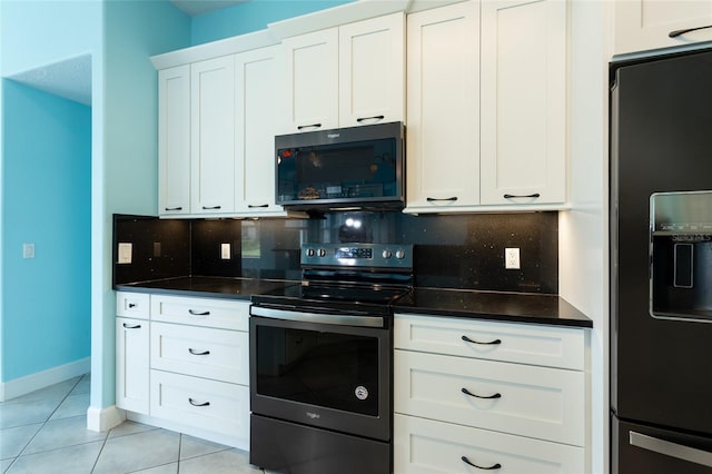 38 Mount Vernon Ln, Palm Coast, FL 32164 - kitchen with refrigerator with ice dispenser, black microwave, electric range, tasteful backsplash, and light tile patterned floors