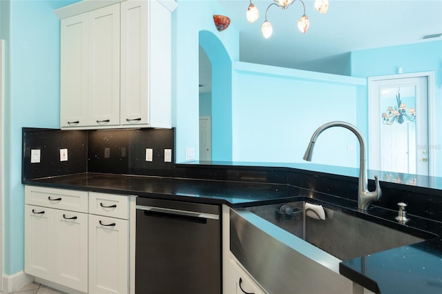 38 Mount Vernon Ln, Palm Coast, FL 32164 - kitchen featuring dishwasher, dark countertops, decorative backsplash, white cabinets, and arched walkways