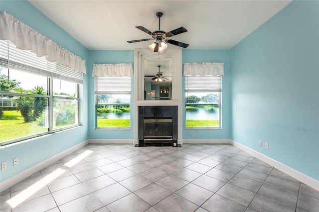 38 Mount Vernon Ln, Palm Coast, FL 32164 - unfurnished living room with a large fireplace, tile patterned flooring, ceiling fan, and a water view