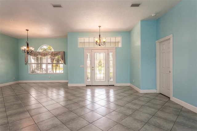 38 Mount Vernon Ln, Palm Coast, FL 32164 - entrance foyer with a chandelier, tile patterned flooring, and a textured ceiling