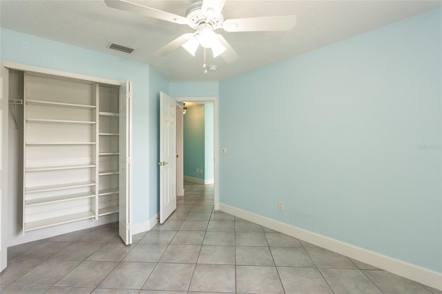 38 Mount Vernon Ln, Palm Coast, FL 32164 - unfurnished bedroom featuring a closet, light tile patterned floors, and a ceiling fan