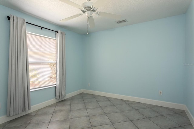 38 Mount Vernon Ln, Palm Coast, FL 32164 - unfurnished room featuring healthy amount of natural light, light tile patterned floors, a textured ceiling, and a ceiling fan