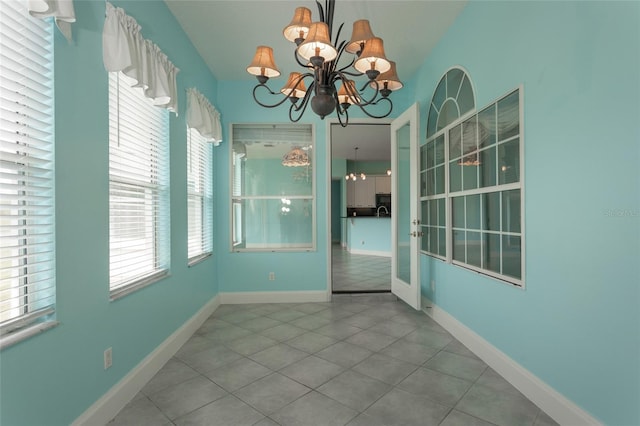 38 Mount Vernon Ln, Palm Coast, FL 32164 - unfurnished dining area featuring tile patterned floors and a chandelier