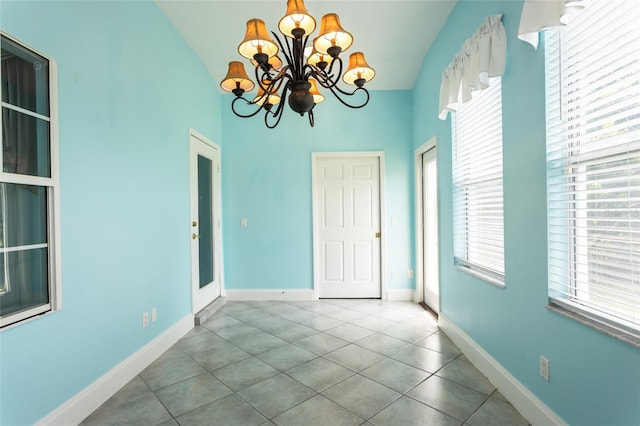 38 Mount Vernon Ln, Palm Coast, FL 32164 - tiled spare room featuring a chandelier, plenty of natural light, and lofted ceiling