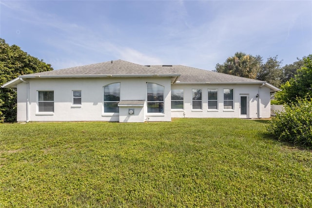 38 Mount Vernon Ln, Palm Coast, FL 32164 - back of house with a yard, stucco siding, and roof with shingles