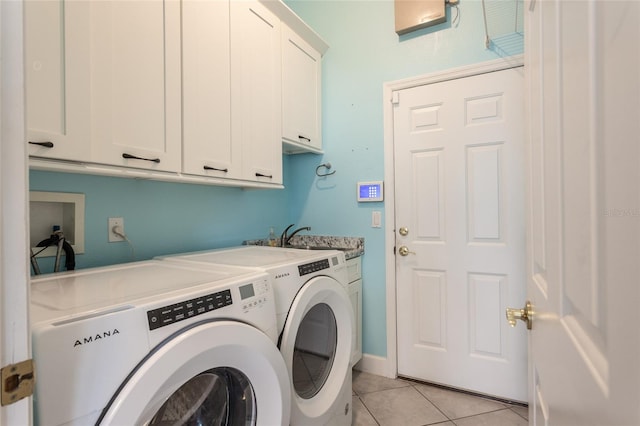 38 Mount Vernon Ln, Palm Coast, FL 32164 - washroom with cabinet space, washing machine and dryer, and light tile patterned floors