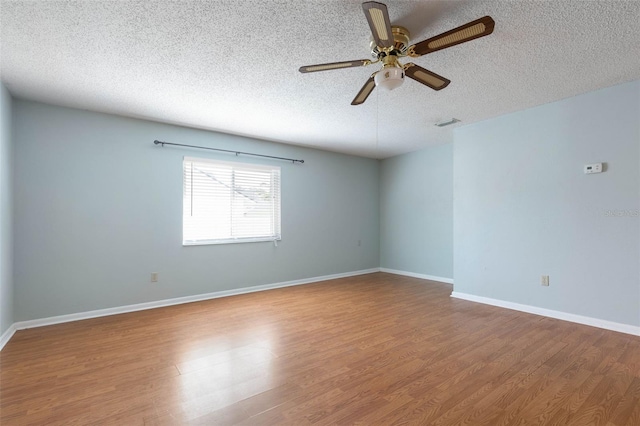 1 Wilson Pl, Palm Coast, FL 32164 - spare room with a textured ceiling, wood finished floors, and a ceiling fan