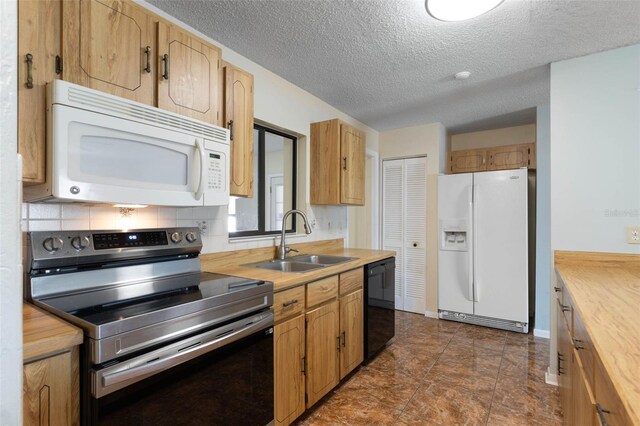 1 Wilson Pl, Palm Coast, FL 32164 - kitchen featuring white appliances, a textured ceiling, and backsplash