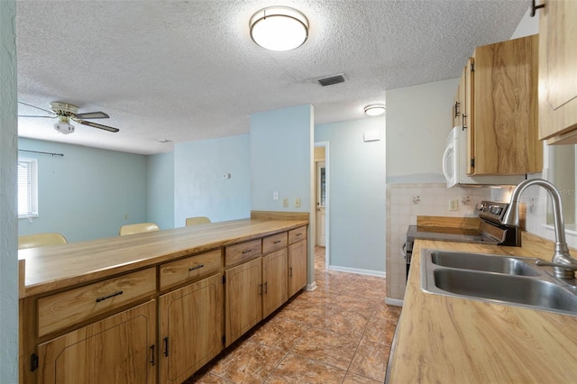 1 Wilson Pl, Palm Coast, FL 32164 - kitchen with electric range, a textured ceiling, ceiling fan, tasteful backsplash, and butcher block countertops