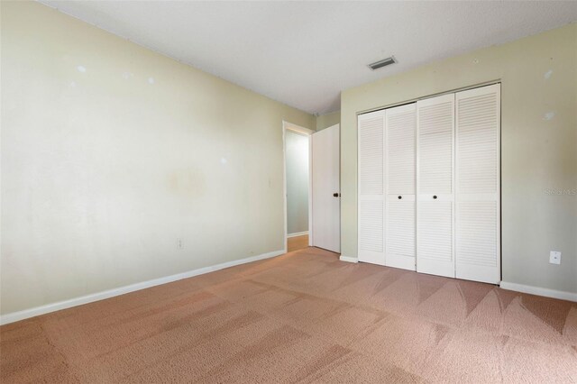 1 Wilson Pl, Palm Coast, FL 32164 - unfurnished bedroom featuring carpet flooring and a closet
