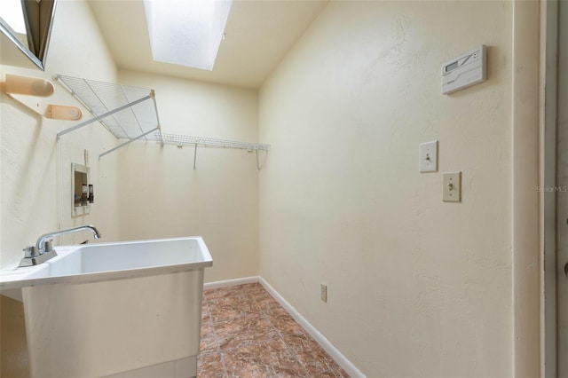 1 Wilson Pl, Palm Coast, FL 32164 - washroom featuring hookup for a washing machine, stone finish flooring, and a skylight