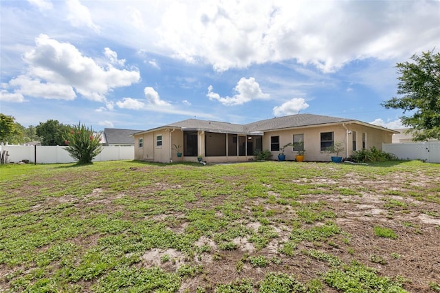 1 Wilson Pl, Palm Coast, FL 32164 - back of house with a sunroom, a fenced backyard, and stucco siding