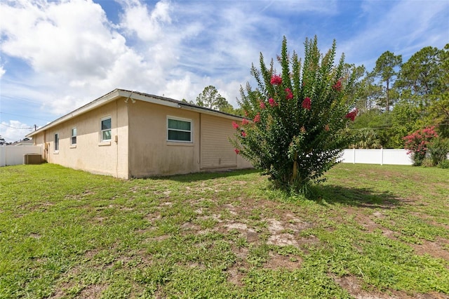 1 Wilson Pl, Palm Coast, FL 32164 - view of home's exterior featuring stucco siding and a cooling unit