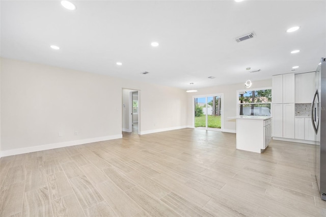 3 Fenwood Ln, Palm Coast, FL 32137 - unfurnished living room with recessed lighting and light wood-type flooring