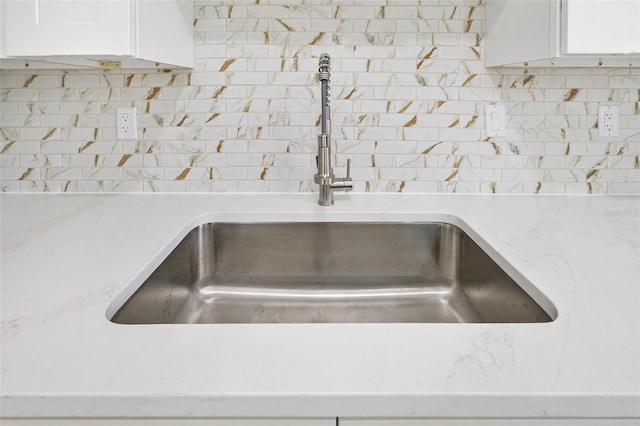 3 Fenwood Ln, Palm Coast, FL 32137 - kitchen view of decorative backsplash, white cabinets, and light stone countertops
