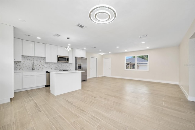 3 Fenwood Ln, Palm Coast, FL 32137 - kitchen featuring appliances with stainless steel finishes, a center island, backsplash, light countertops, and recessed lighting