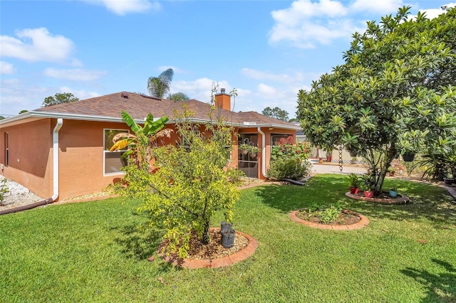 5 Zorlou Ct, Palm Coast, FL 32164 - rear view of house with a lawn, stucco siding, and a chimney