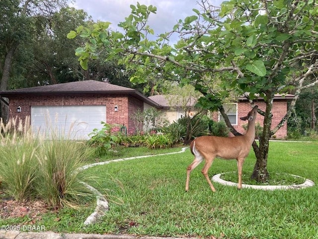 1108 Northside Dr, Ormond Beach, FL 32174 - view of front facade featuring brick siding, a garage, and a front yard