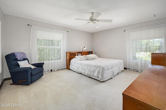 1108 Northside Dr, Ormond Beach, FL 32174 - bedroom featuring light carpet, a textured ceiling, and a ceiling fan