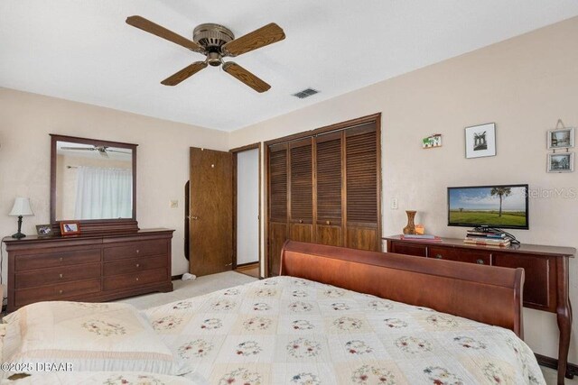 1108 Northside Dr, Ormond Beach, FL 32174 - bedroom featuring a closet, a ceiling fan, and carpet