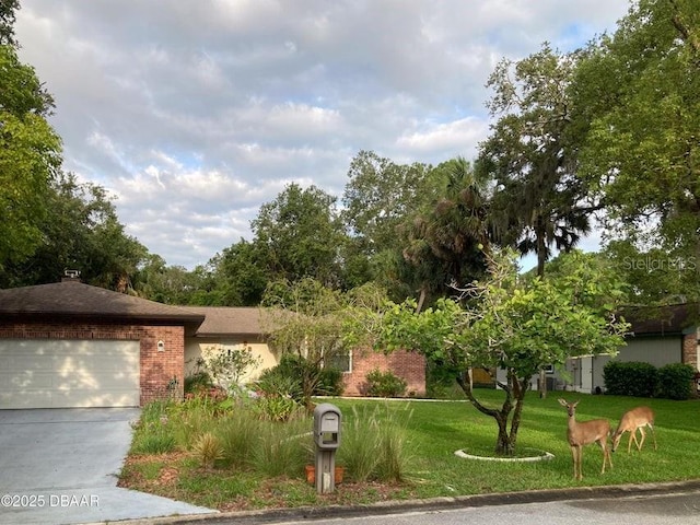 1108 Northside Dr, Ormond Beach, FL 32174 - view of front of home featuring brick siding, a front lawn, a garage, and driveway