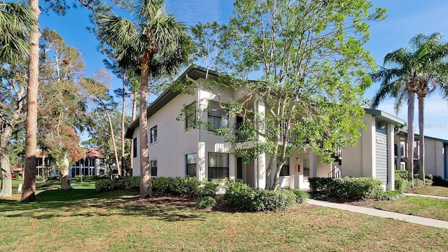 4655 46th Street Ct W Unit 101, Bradenton, FL 34210 - view of home's exterior with stucco siding and a yard