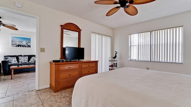 4655 46th Street Ct W Unit 101, Bradenton, FL 34210 - bedroom featuring light tile patterned flooring, a textured ceiling, and a ceiling fan