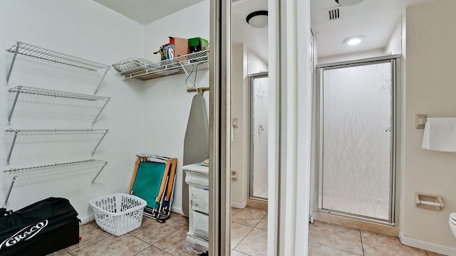 4655 46th Street Ct W Unit 101, Bradenton, FL 34210 - bathroom featuring a shower stall and tile patterned floors