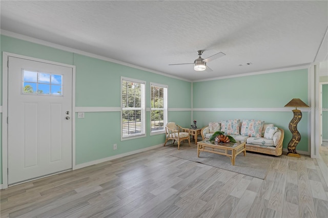 606 Ofarrell Ave, Interlachen, FL 32148 - living room with plenty of natural light, wood finished floors, a ceiling fan, ornamental molding, and a textured ceiling