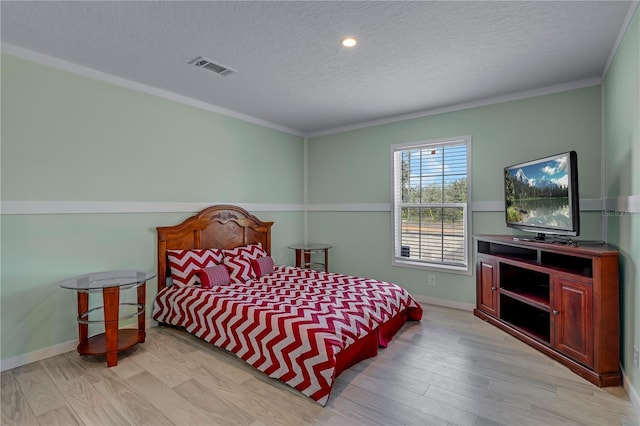 606 Ofarrell Ave, Interlachen, FL 32148 - bedroom with a textured ceiling, light wood-style floors, and ornamental molding