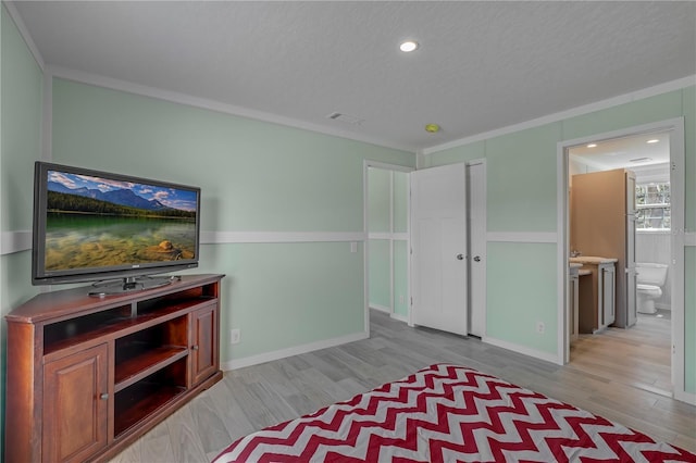606 Ofarrell Ave, Interlachen, FL 32148 - unfurnished bedroom featuring wood finished floors, ensuite bathroom, recessed lighting, and crown molding