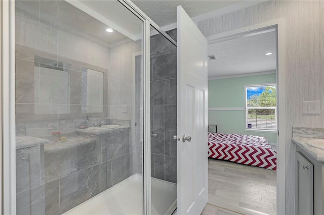 606 Ofarrell Ave, Interlachen, FL 32148 - full bath with vanity, wood finished floors, a stall shower, ensuite bathroom, and recessed lighting