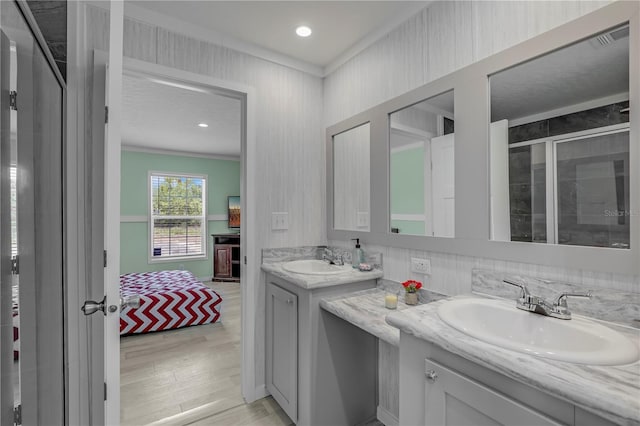 606 Ofarrell Ave, Interlachen, FL 32148 - ensuite bathroom featuring vanity, wood finished floors, a shower stall, ornamental molding, and recessed lighting