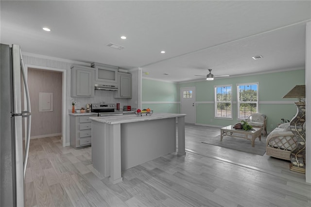 606 Ofarrell Ave, Interlachen, FL 32148 - kitchen with appliances with stainless steel finishes, gray cabinetry, open floor plan, ornamental molding, and a ceiling fan