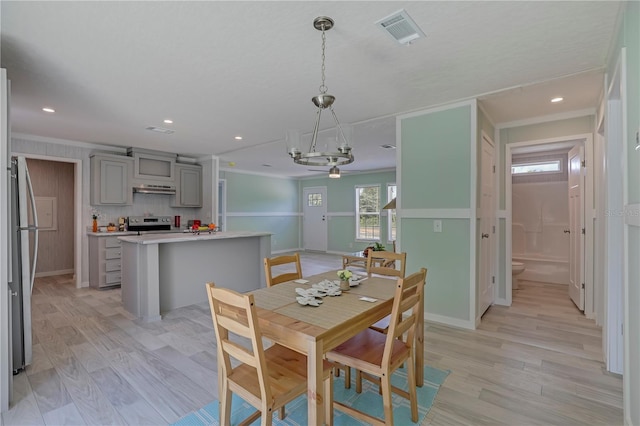 606 Ofarrell Ave, Interlachen, FL 32148 - dining area with light wood-style floors, recessed lighting, and crown molding