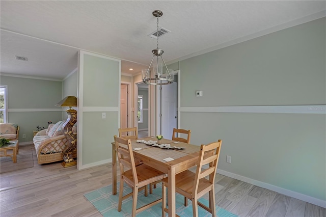 606 Ofarrell Ave, Interlachen, FL 32148 - dining room featuring light wood finished floors, a chandelier, and ornamental molding