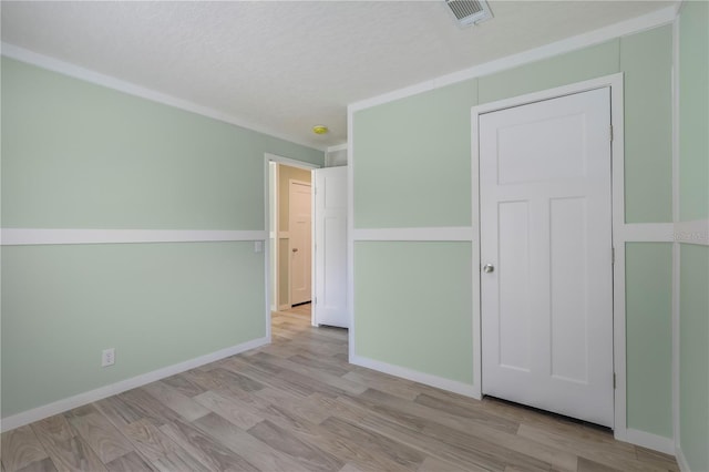 606 Ofarrell Ave, Interlachen, FL 32148 - unfurnished bedroom with wood finished floors and a textured ceiling