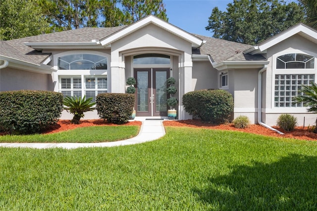 7 Lewis Shire Way, Palm Coast, FL 32137 - view of front of home featuring stucco siding, roof with shingles, french doors, and a front lawn