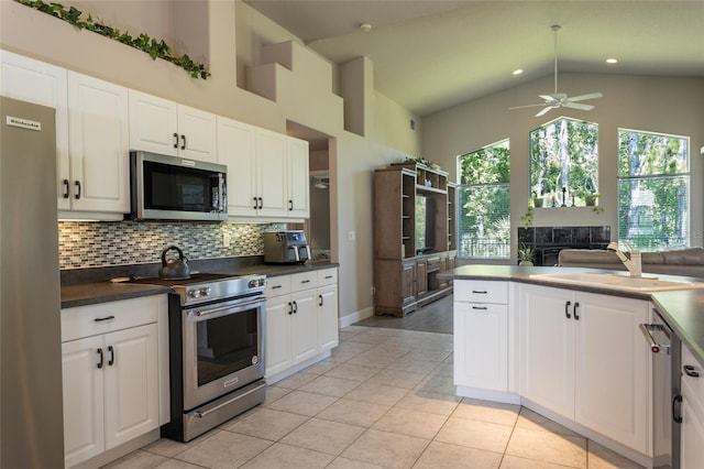7 Lewis Shire Way, Palm Coast, FL 32137 - kitchen with appliances with stainless steel finishes, backsplash, high vaulted ceiling, light tile patterned floors, and a ceiling fan