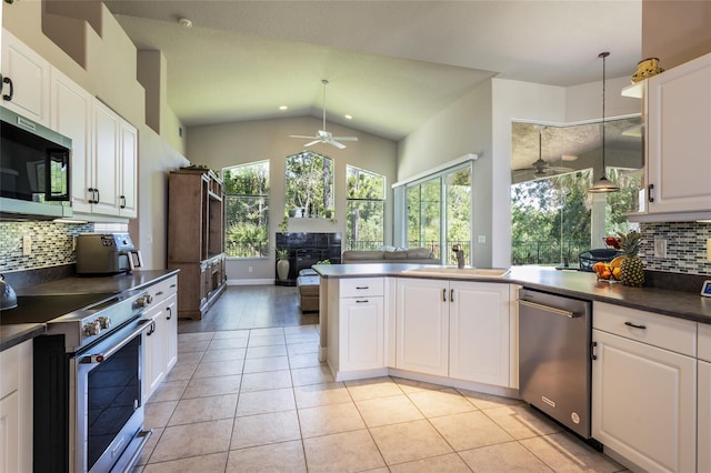 7 Lewis Shire Way, Palm Coast, FL 32137 - kitchen with appliances with stainless steel finishes, ceiling fan, dark countertops, plenty of natural light, and vaulted ceiling