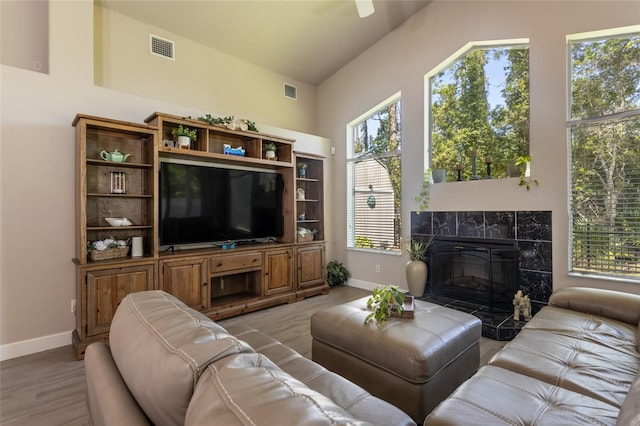 7 Lewis Shire Way, Palm Coast, FL 32137 - living room with light wood-style flooring, a tile fireplace, ceiling fan, and lofted ceiling