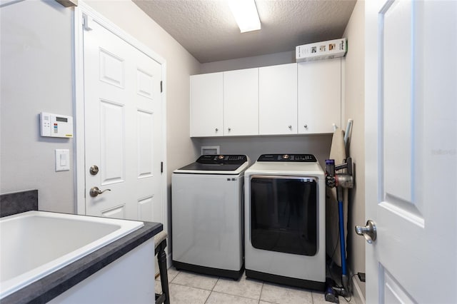 7 Lewis Shire Way, Palm Coast, FL 32137 - laundry area featuring cabinet space, independent washer and dryer, a textured ceiling, and light tile patterned floors