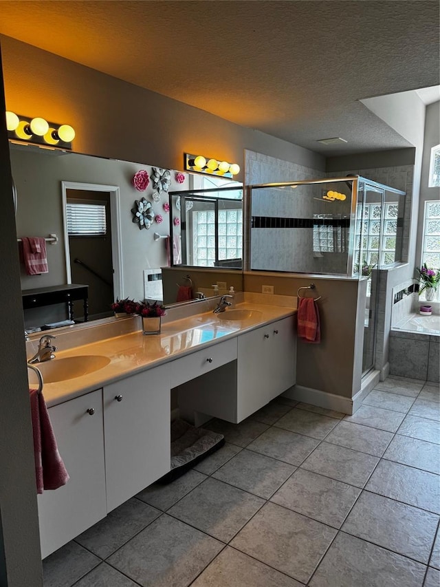 7 Lewis Shire Way, Palm Coast, FL 32137 - bathroom featuring double vanity, healthy amount of natural light, a shower stall, tile patterned flooring, and a textured ceiling
