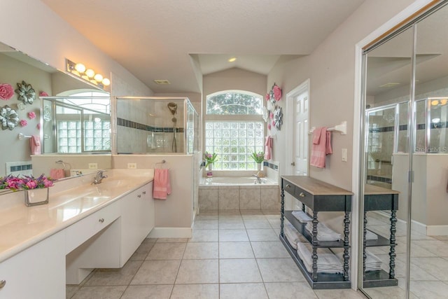 7 Lewis Shire Way, Palm Coast, FL 32137 - bathroom featuring vanity, a garden tub, tile patterned floors, a stall shower, and vaulted ceiling