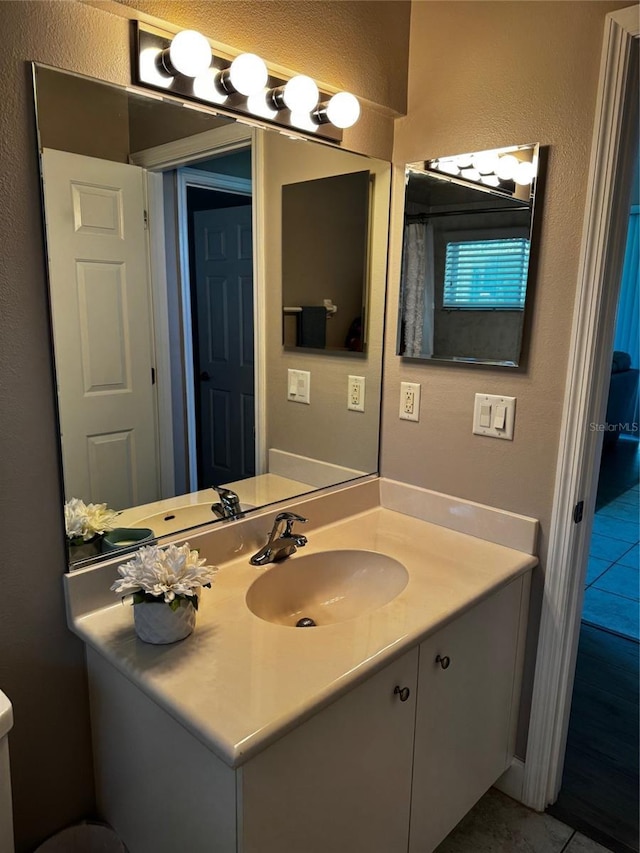 7 Lewis Shire Way, Palm Coast, FL 32137 - bathroom with vanity, tile patterned flooring, and a textured wall