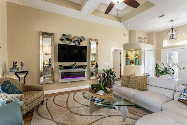 20 Long Pl, Palm Coast, FL 32137 - living room with wood finished floors, a glass covered fireplace, and a ceiling fan
