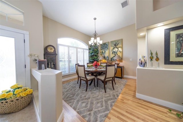 20 Long Pl, Palm Coast, FL 32137 - dining room with a chandelier, high vaulted ceiling, and wood finished floors