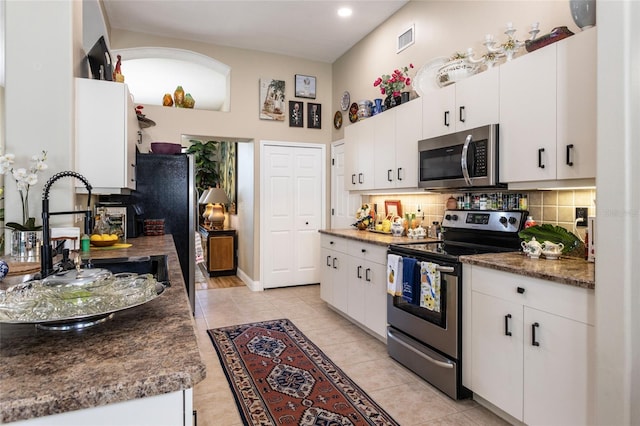 20 Long Pl, Palm Coast, FL 32137 - kitchen with stainless steel appliances, tasteful backsplash, white cabinetry, light tile patterned flooring, and recessed lighting